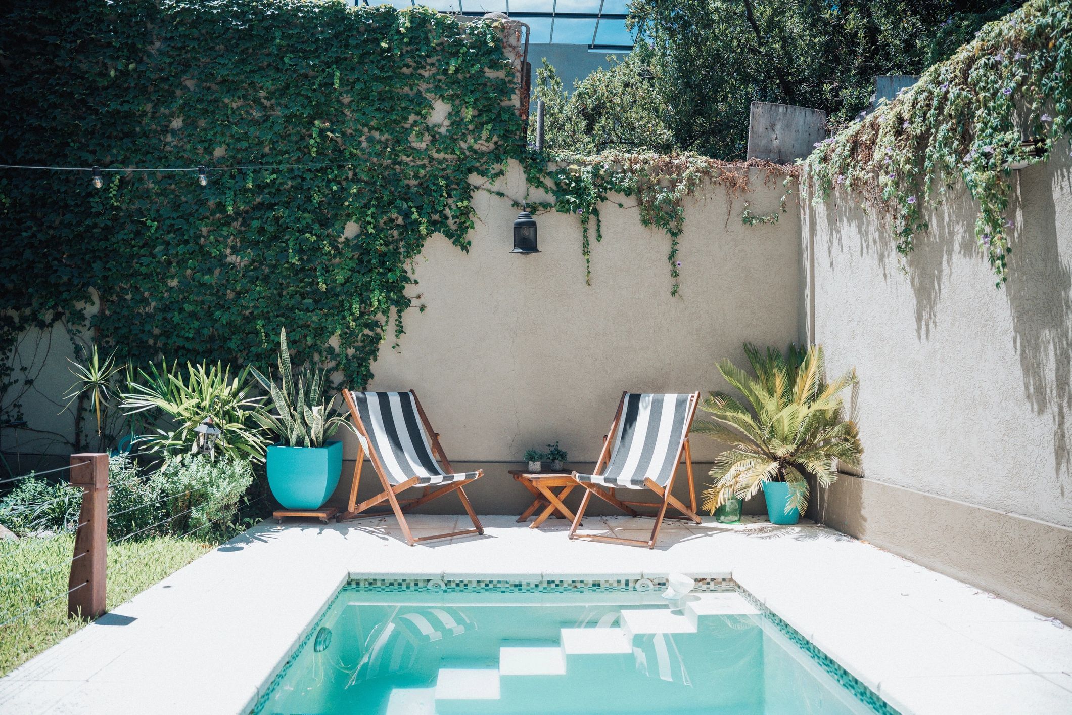 Backyard pool with lounge chairs in the sun